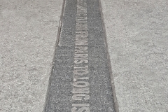 Passerby Crosses Over Granite Commemorative Paver-Canyon Of Heroes, Financial District, NYC