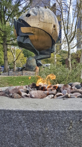 Eternal Flame For 9-11 Victims With Sphere Sculpture Behind It